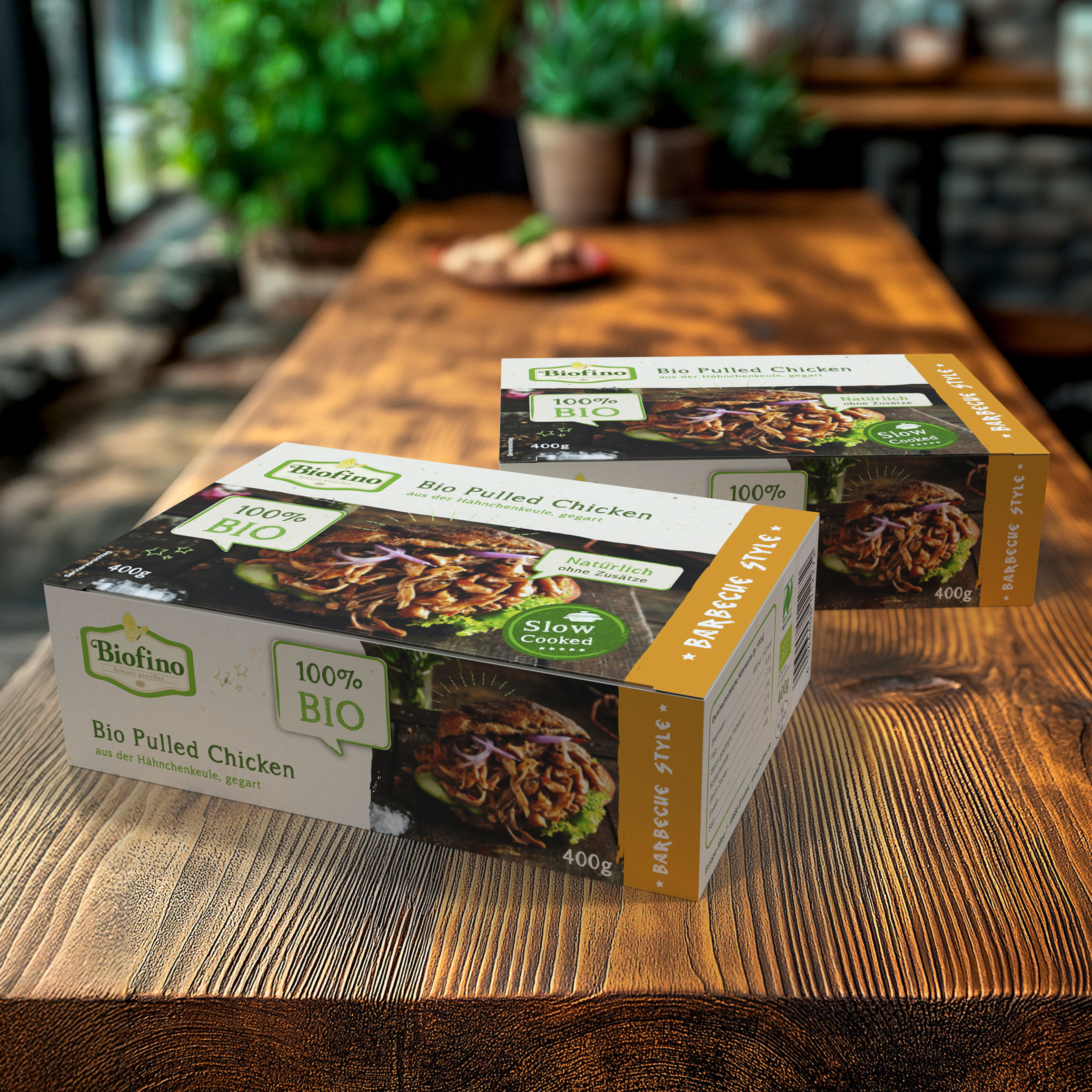 Referenz Biofino Klappdeckelschachteln. Auf der Verpackung "Bio Pulled Chicken 100% BIO"
